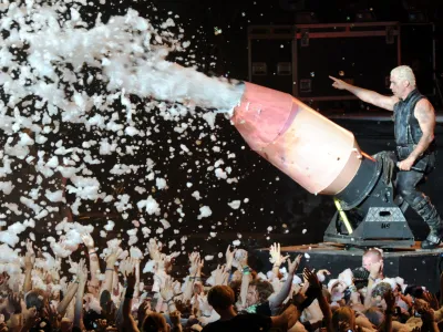 FILED - 01 August 2013, Schleswig-Holstein, Wacken: Till Lindemann, lead singer of the German metal band Rammstein, sprays the audience with a foam cannon during a concert in Wacken. Lawyers for Till Lindemann say they will take legal action against those alleging he committed crimes against women. Photo: Carsten Rehder/dpa