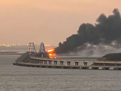 A view shows a fire on the Kerch bridge at sunrise in the Kerch Strait, Crimea, October 8, 2022. REUTERS/Stringer