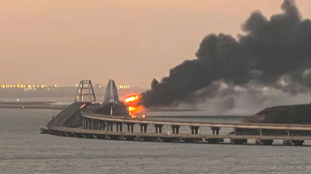A view shows a fire on the Kerch bridge at sunrise in the Kerch Strait, Crimea, October 8, 2022. REUTERS/Stringer