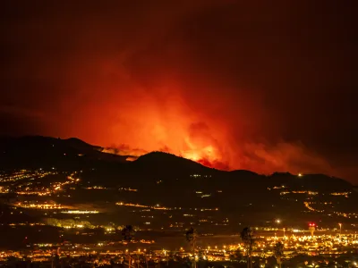 Flares are seen on the horizon as the fire advances through the forest toward the town of La Laguna and Los Rodeos airport in Tenerife, Canary Islands, Spain on Saturday, Aug. 19, 2023. Firefighters have battled through the night to try to bring under control the worst wildfire in decades on the Spanish Canary Island of Tenerife, a major tourist destination. The fire in the north of the island started Tuesday night and has forced the evacuation or confinement of nearly 8,000 people. Regional officials say Friday's efforts will be crucial in containing the fire. (AP Photo/Arturo Rodriguez)