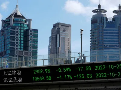 FILE PHOTO: An electronic board shows Shanghai and Shenzhen stock indexes, at the Lujiazui financial district in Shanghai, China October 25, 2022. REUTERS/Aly Song/File Photo/File Photo