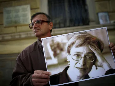 A protester holds a picture of murdered Russian journalist Anna Politkovskaya during a demonstration for freedom of speech and the press in Sofia October 7, 2008. Politkovskaya, a critic of the former Russian President Putin, was shot dead in her Moscow apartment building two years ago. REUTERS/Stoyan Nenov  (BULGARIA)