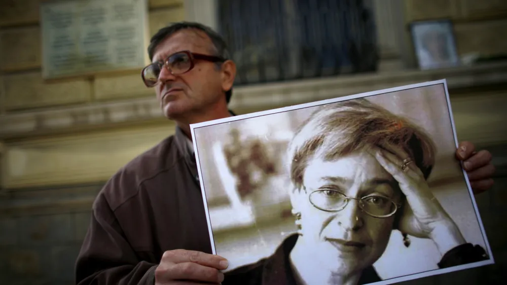 A protester holds a picture of murdered Russian journalist Anna Politkovskaya during a demonstration for freedom of speech and the press in Sofia October 7, 2008. Politkovskaya, a critic of the former Russian President Putin, was shot dead in her Moscow apartment building two years ago. REUTERS/Stoyan Nenov  (BULGARIA)