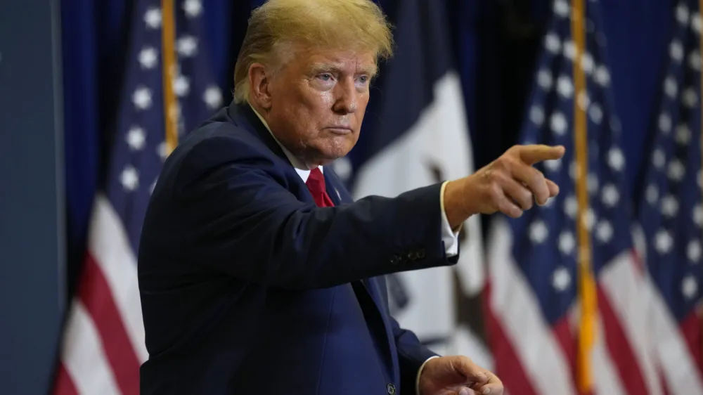 Former President Donald Trump leaves the stage during a commit to caucus rally, Friday, Jan. 5, 2024, in Mason City, Iowa. (AP Photo/Charlie Neibergall)