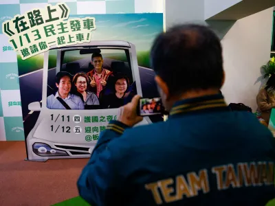 A supporter of the Democratic Progressive Party (DPP) poses for a picture during a rally, following the victory of Lai Ching-te in the presidential elections, in Taipei, Taiwan January 13, 2024. REUTERS/Ann Wang