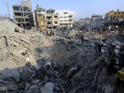 Palestinians inspect the damage of buildings that were hit by Israeli airstrikes in Jabaliya refugee camp, northern Gaza Strip, Wednesday, Nov. 1, 2023. (AP Photo/Abed Khaled)