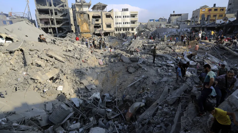 Palestinians inspect the damage of buildings that were hit by Israeli airstrikes in Jabaliya refugee camp, northern Gaza Strip, Wednesday, Nov. 1, 2023. (AP Photo/Abed Khaled)