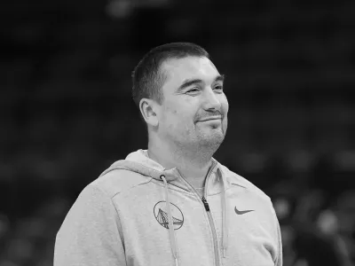 Golden State Warriors assistant coach Dejan Milojevic watches players warm up before an NBA preseason basketball game against the Denver Nuggets in San Francisco, Friday, Oct. 14, 2022. Warriors assistant coach Dejan Milojević, a mentor to two-time NBA MVP Nikola Jokic and a former star player in his native Serbia, died Wednesday, Jan. 17, 2024, after suffering a heart attack, the team announced. Milojević, part of the staff that helped the Warriors win the 2022 NBA championship, was 46. (AP Photo/Jeff Chiu)