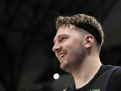 Dallas Mavericks guard Luka Doncic smiles after sinking a three-point basket in the first half of an NBA basketball game against the Phoenix Suns in Dallas, Wednesday, Jan. 24, 2024. (AP Photo/Tony Gutierrez)