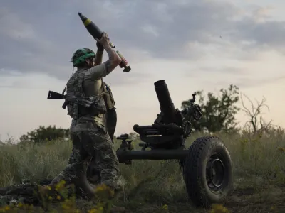 FILE - A Ukrainian serviceman of the 3rd Assault Brigade fires a 122mm mortar towards Russian positions at the front line, near Bakhmut, Donetsk region, Ukraine, Sunday, July 2, 2023. Employees from a Ukrainian arms firm conspired with defense ministry officials to embezzle almost  million earmarked to buy 100,000 mortar shells for the war with Russia, Ukraine's security service reported. The SBU said late Saturday, Jan. 27, 2024 that five people have been charged and the money has been recovered. (AP Photo/Alex Babenko, File)