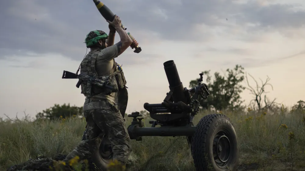 FILE - A Ukrainian serviceman of the 3rd Assault Brigade fires a 122mm mortar towards Russian positions at the front line, near Bakhmut, Donetsk region, Ukraine, Sunday, July 2, 2023. Employees from a Ukrainian arms firm conspired with defense ministry officials to embezzle almost $40 million earmarked to buy 100,000 mortar shells for the war with Russia, Ukraine's security service reported. The SBU said late Saturday, Jan. 27, 2024 that five people have been charged and the money has been recovered. (AP Photo/Alex Babenko, File)
