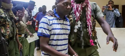 FILE PHOTO: Paul Mackenzie, a Kenyan cult leader accused of ordering his followers, who were members of the Good News International Church, to starve themselves to death in Shakahola forest, is escorted to the Malindi Law Courts in Malindi, Kilifi, Kenya January 17, 2024. REUTERS/Stringer/File Photo