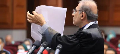 07 May 2024, Iran, Tehran: An Iranian lawyer shows a document to the audience at Imam Khomeini Judicial Complex Court during the hearing of the complaint of Iranian thalassemia patients against the United States, the government, and other defendants in Tehran. Photo: Rouzbeh Fouladi/ZUMA Press Wire/dpa