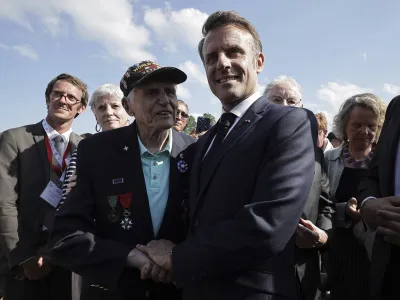 French President Emmanuel Macron meets with US WW II veteran Steven Melnikoff, center left, during a ceremony in tribute to the civilian victims of World War II, ahead of celebrations for the 80th anniversary of D-Day landing in Normandy, in Saint-Lo, Wednesday, June 52024. (Christophe Petit Tesson, Pool via AP)