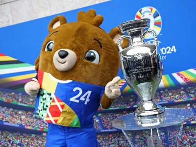 Soccer Football - Euro 2024 - Trophy Display at Olympiastadion - Olympiastadion, Berlin, Germany - April 24, 2024 Euro 2024 mascot Albart poses with the European Championship trophy REUTERS/Liesa Johannssen