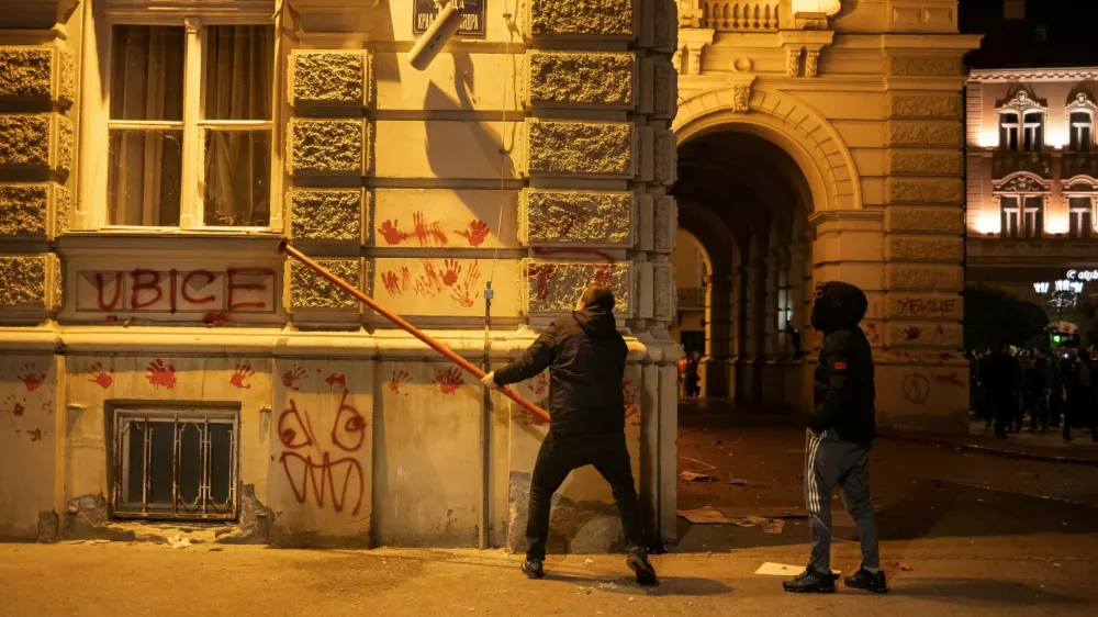 A demonstrator destroys a surveillance camera during a protest over an accident at a railway station in the Serbian city of Novi Sad, for which they blame negligence and corruption by the authorities, in front of the city hall of Novi Sad, Serbia November 5, 2024. REUTERS/Marko Djurica