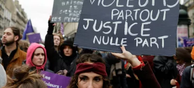 A woman holds a placard as people attend a demonstration to protest against femicide, sexual violence and all gender-based violence to mark the International Day for Elimination of Violence Against Women, in Paris, France, November 23, 2024. The placard reads: "Rapists everywhere justice nowhere". REUTERS/Abdul Saboor