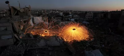 Palestinians spin steel wool sparklers amid the rubble of buildings, ahead of the holy fasting month of Ramadan, amid a ceasefire between Israel and Hamas, at Jabalia refugee camp, northern Gaza Strip, February 28, 2025. REUTERS/Mahmoud Issa   TPX IMAGES OF THE DAY