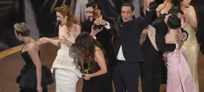 Daria Ekamasova, from left, Lindsey Normington, Samantha Quan, Vache Tovmasyan, Karren Karagulian, Alex Coco, and Mikey Madison accept the award for best picture for "Anora" during the Oscars on Sunday, March 2, 2025, at the Dolby Theatre in Los Angeles. (AP Photo/Chris Pizzello)