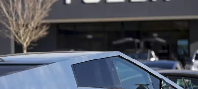 A Tesla Cybertruck and other Telsla vehicles sit at a dealership, Wednesday, March 19, 2025, in Kennesaw, Ga. (AP Photo/Mike Stewart)