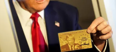 U.S. President Donald Trump holds "The Trump Card" as he speaks with journalists onboard Air Force One en route to Miami, Florida, U.S., April 3, 2025. REUTERS/Kent Nishimura