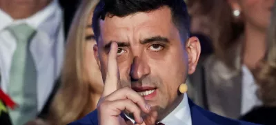 Presidential candidate George Simion reacts to exit polls of Romania's second round of the presidential election, in front of the parliament in Bucharest, Romania, May 18, 2025. REUTERS/Louisa Gouliamaki