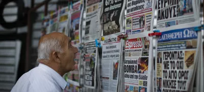 ﻿A man looks at the newspapers at a newsstand in central Athens, Monday, July 6, 2015. Greece's finance minister has resigned following Sunday's referendum in which the majority of voters said "no" to more austerity measures in exchange for another financial bailout. (AP Photo/Emilio Morenatti)