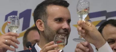 Milojko Spajic, president of the centrist Europe Now party raises a glass of champagne at his headquarters after parliamentary election in Montenegro's capital Podgorica, Sunday, June 11, 2023. A recently formed centrist group that advocates Montenegro joining the European Union was projected to win the small Balkan country's early parliamentary election Sunday, but without enough support to form a government on its own, according to independent vote monitors. (AP Photo/Risto Bozovic)