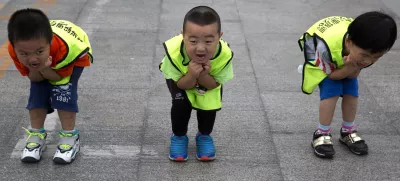 Children practice their postures during a roller blading class outside a park in Beijing, China, Wednesday, June 24, 2015. Roller blading has grown in popularity as instructors and equipment become more easily available in the Chinese capital.  (AP Photo/Ng Han Guan)