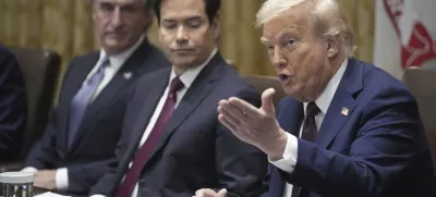 President Donald Trump speaks during a cabinet meeting, Tuesday, Aug. 26, 2025, at the White House in Washington, as from left, Secretary of Interior Doug Burgum and Secretary of State Marco Rubio, look on. (AP Photo/Mark Schiefelbein)