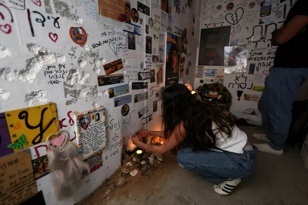 People pay tribute at a bomb shelter near Reim, as they commemorate the two-year anniversary of the deadly October 7, 2023 attack on Israel by Hamas from Gaza, southern Israel, October 7, 2025. REUTERS/Ronen Zvulun