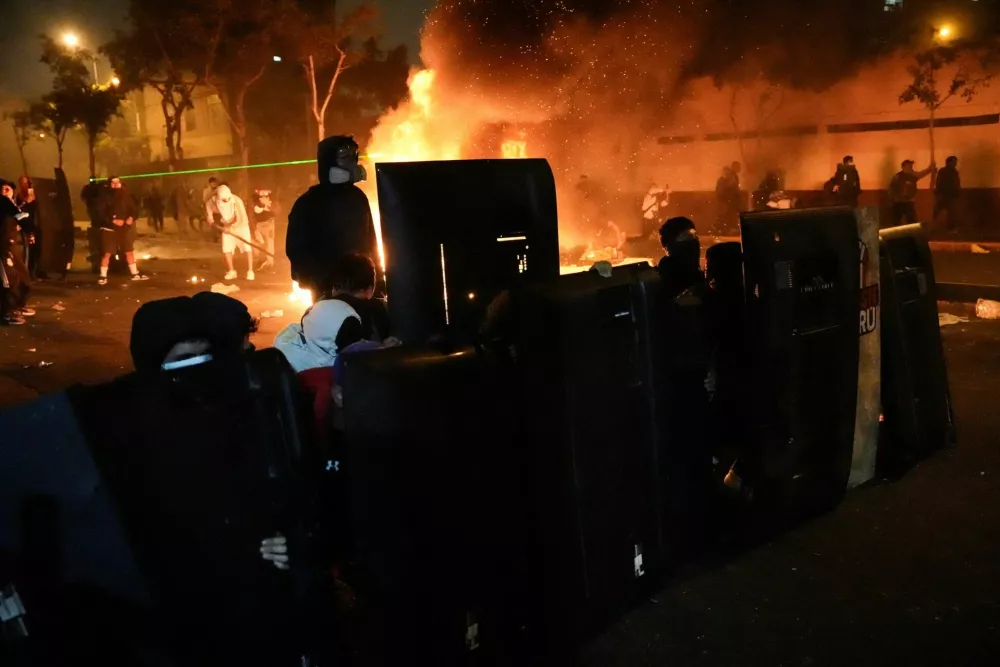 Demonstrators hold shields next to fire burning during a protest against rising crime, economic insecurity, and corruption, a day after President Jose Jeri presented his cabinet, in Lima, Peru, October 15, 2025. REUTERS/Angela Ponce