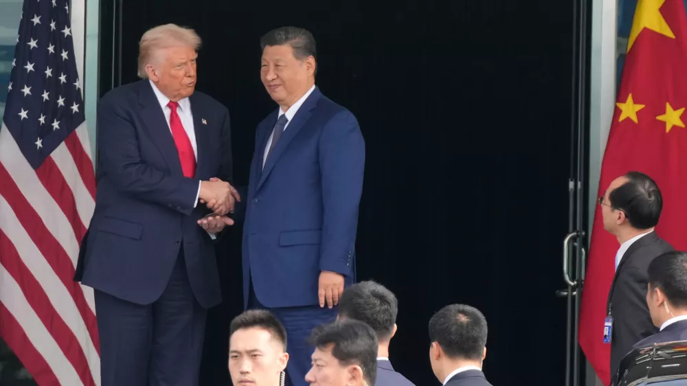 President Donald Trump, left, and Chinese President Xi Jinping, right, shake hands after their U.S.-China summit meeting at Gimhae International Airport Jinping in Busan, South Korea, Thursday, Oct. 30, 2025. (AP Photo/Mark Schiefelbein)