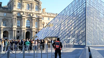 People queue to enter the Louvre museum, Thursday, Oct. 30, 2025 in Paris. (AP Photo/Emma Da Silva)