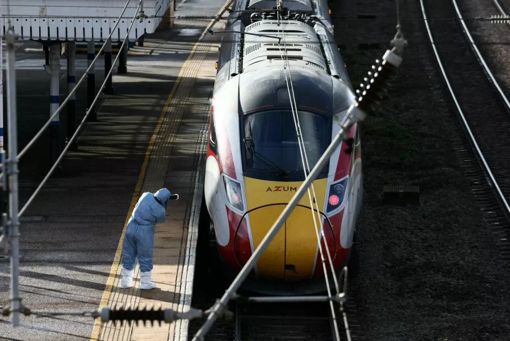 A forensic officer takes pictures of the London North Eastern Railway (LNER) train where a series of stabbings took place, at a platform at Huntingdon Station, near Cambridge, Britain, November 2, 2025. REUTERS/Jack Taylor