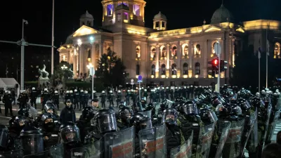 Law enforcement officers in riot gear stand guard as they separate anti-government protesters and supporters of Serbian President Aleksandar Vucic, near the parliament building in Belgrade, Serbia, November 2, 2025. REUTERS/Marko Djurica