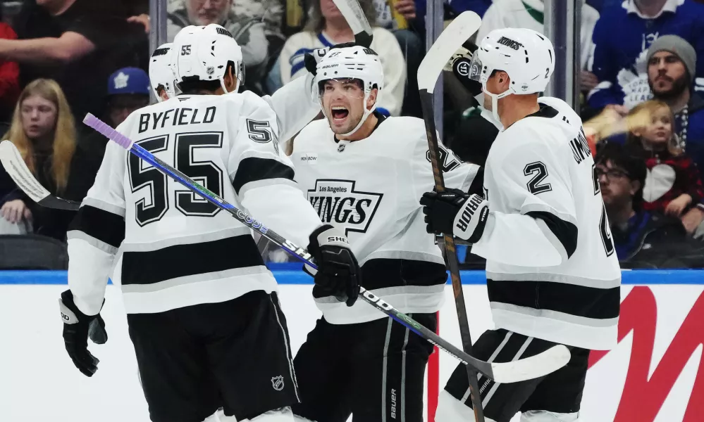 Los Angeles Kings' Kevin Fiala (second right) celebrates his goal against the Toronto Maple Leafs with Quinton Byfield (55) and Brian Dumoulin (2) during second period NHL hockey in Toronto on Thursday, Nov. 13, 2025. (Nathan Denette/The Canadian Press via AP)
