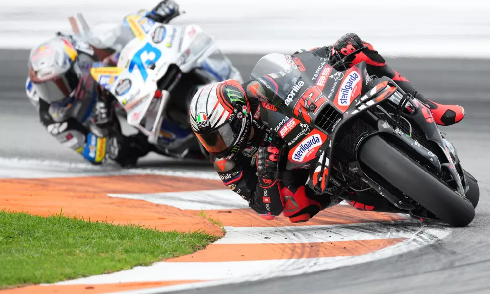 Italian rider Marco Bezzecchi of the Aprilia Racing, right, and Spain's rider Alex Marquez of the BK8 Gresini Racing MotoGP, left, compete during the Valencia Motorcycle MotoGP Grand Prix at the Ricardo Tormo circuit in Cheste, near Valencia, Spain, Sunday, Nov. 16, 2025. (AP Photo/Alberto Saiz)