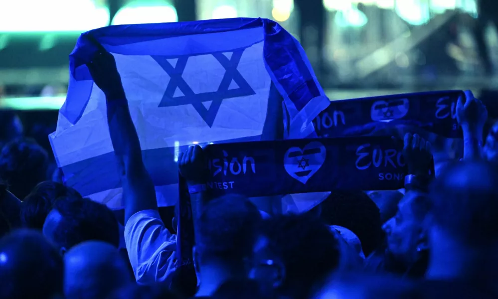 17 May 2025, Switzerland, Basel: A person holds an Israeli flag during the Grand Final of the Eurovision Song Contest 2025 in Basel. The European Broadcasting Union (EBU), which organizes Eurovision, said on Thursday that it will hold an online meeting in November to vote on participation in the 2026 contest, as debate over Israel's involvement continues to stir controversy. Photo: Heikki Saukkomaa/Lehtikuva/dpa