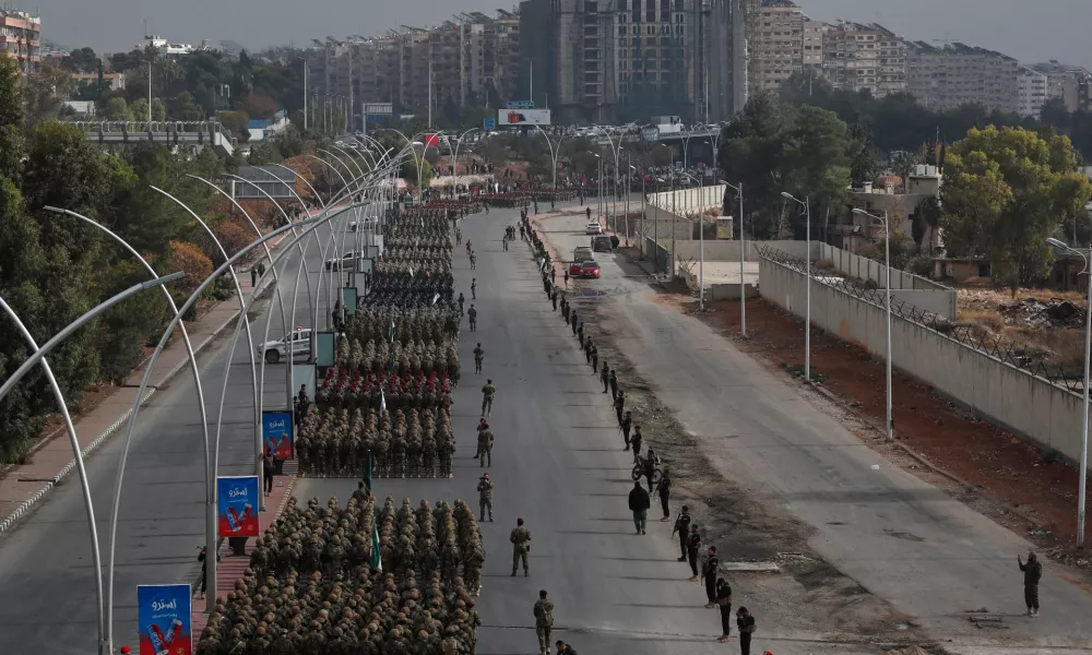 Members of the new Syrian army line up in formation during a parade marking the first anniversary of the ousting of former President Bashar Assad, in Damascus, Syria, Monday, Dec. 8, 2025. (AP Photo/Omar Sanadiki)