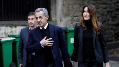 Former French President Nicolas Sarkozy leaves his house with his wife Carla Bruni-Sarkozy on the day of his incarceration at the Sante prison to begin his five-year prison sentence for criminal conspiracy over attempts to raise campaign funds from Libya, in Paris, France, October 21, 2025. REUTERS/Benoit Tessier