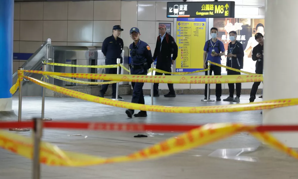 Taiwan police cordoned off the scene after a knife attack in Taipei, Taiwan, Friday, Dec. 19, 2025. (AP Photo/Chiang Ying-ying)
