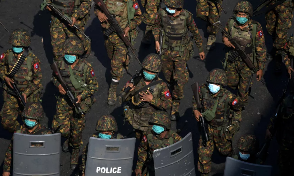 FILE PHOTO: Myanmar soldiers from the 77th light infantry division walk along a street during a protest against the military coup in Yangon, Myanmar, February 28, 2021. Picture taken February 28, 2021. REUTERS/Stringer/File Photo