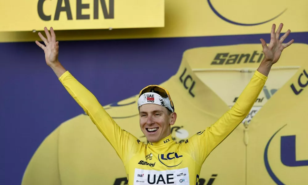 Cycling - Tour de France - Stage 5 - Caen to Caen - Caen, France - July 9, 2025 UAE Team Emirates XRG's Tadej Pogacar celebrates on the podium wearing the yellow jersey after stage 5 REUTERS/Benoit Tessier