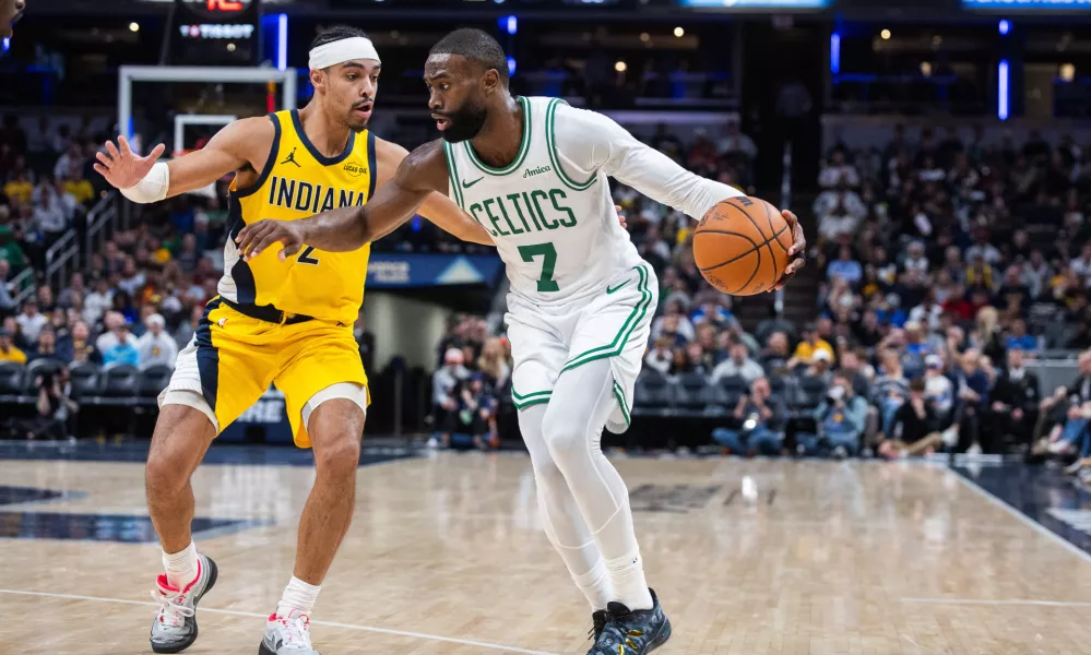 Dec 26, 2025; Indianapolis, Indiana, USA; Boston Celtics guard/forward Jaylen Brown (7) dribbles the ball while Indiana Pacers guard/forward Andrew Nembhard (2) defends in the second half at Gainbridge Fieldhouse. Mandatory Credit: Trevor Ruszkowski-Imagn Images