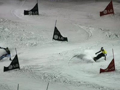 Winner Aaron March of Italy, left, competes with the second placed Benjamin Karl of Austria during a men's parallel slalom Snowboard FIS World Cup in Moscow, Russia, Saturday, March 6, 2010. (AP Photo/Mikhail Metzel)