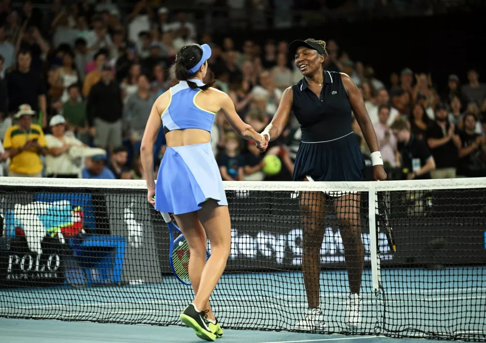 Tennis - Australian Open - Melbourne Park, Melbourne, Australia - January 18, 2026 Serbia's Olga Danilovic shakes hands with Venus Williams of the U.S. after winning her first round match REUTERS/Jaimi Joy