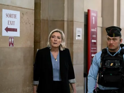 20 January 2026, France, Paris: Marine Le Pen, President of the parliamentary group of the French far-right Rassemblement National party, leaves the courtroom during a break in the appeal trial of Rassemblement National parliamentary assistants on suspicion of embezzling European public funds at the Paris courthouse. Photo: Bertrand Guay/AFP/dpa