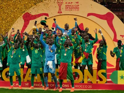 Senegalese players celebrate after winning the Africa Cup of Nations final soccer match agaisnt Morocco, in Rabat, Morocco, Sunday, Jan. 18, 2026. (AP Photo/Mosa'ab Elshamy)