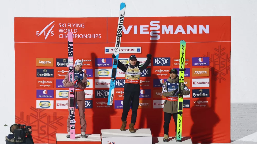 Ski Jumping - Ski Flying World Championships - Heini-Klopfer Ski Flying Hill, Oberstdorf, Germany - January 24, 2026 Slovenia's Domen Prevc celebrates on the podium after winning the men's individual HS235 with second placed Norway's Marius Lindvik and third placed Japan's Ren Nikaido REUTERS/Kai Pfaffenbach